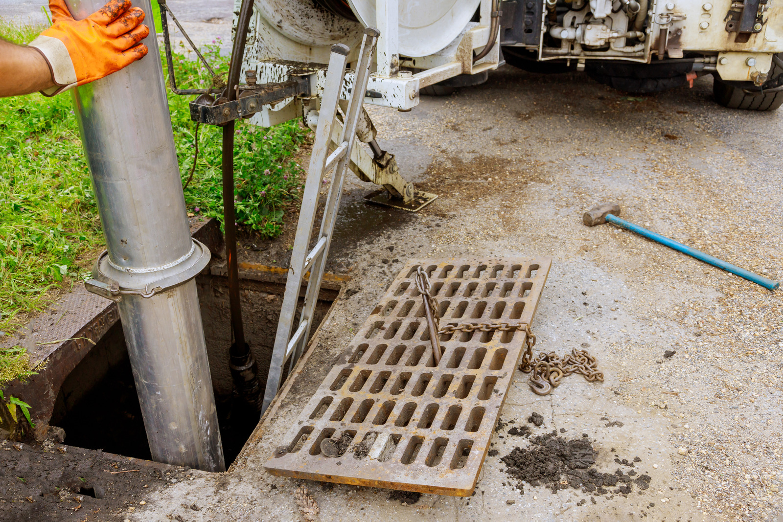 Plumber cleaning sewer line with specialized equipment