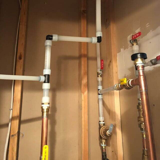 A2B Plumbing technician in Burnaby, BC, inspecting a residential home for re-piping needs.